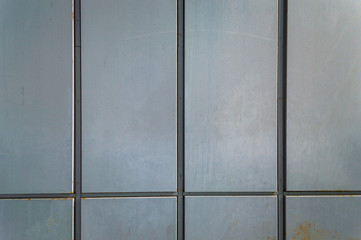 Close up of a corrugated gray metal siding panel