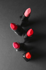 Many lipsticks on dark background