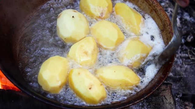 Potatoes fried in a pan in outdoor