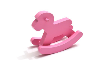 Różowy drewniany konik na biegunach. Pink wooden rocking horse. - obrazy, fototapety, plakaty