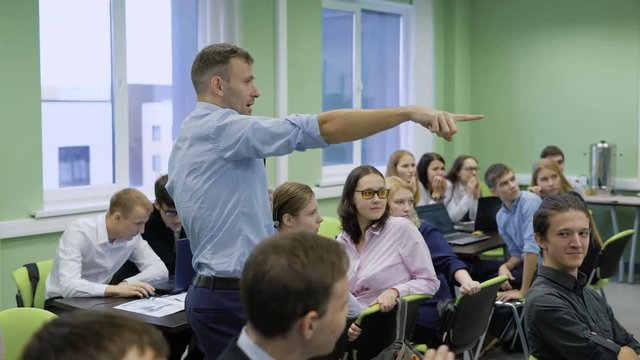 The audience in the business center. Renowned coach leads a workshop for students. Training workshops.