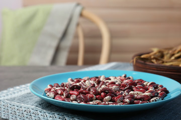 Blue plate with dried haricot beans and napkin on  table