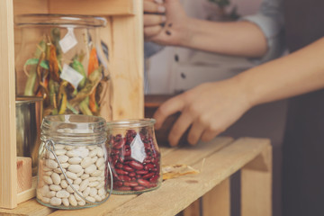 Glass jars with haricot beans on table