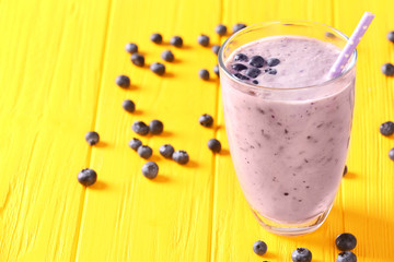 Blueberry milkshake on wooden background
