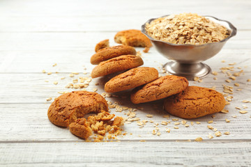 Diet cookies with oatmeal on white wooden background