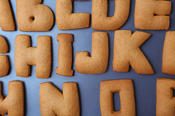 Cookie alphabet on dark background, closeup