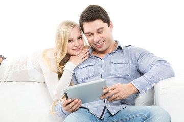 Fototapeta premium Happy couple using laptop on the sofa.