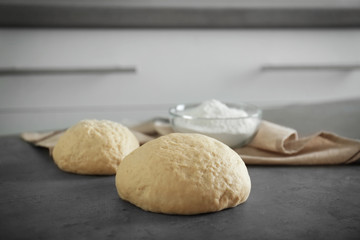 Raw dough on kitchen table