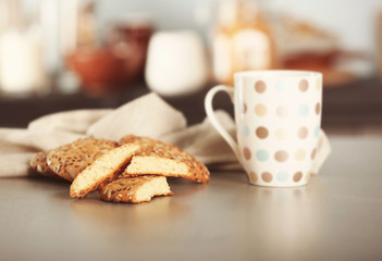 Fototapeta na wymiar Cereal cookies with cup of coffee on kitchen table