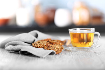 Cereal cookies with cup of tea on wooden table