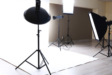 Empty photo studio with lighting equipment