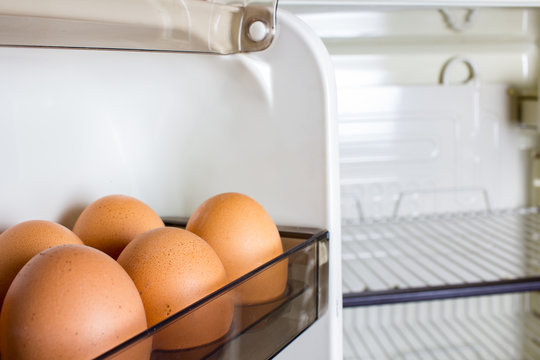 chicken eggs in an empty refrigerator