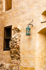Old lantern. Building. Wall. Facade.