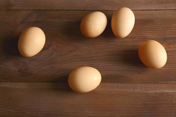 Raw eggs on wooden background