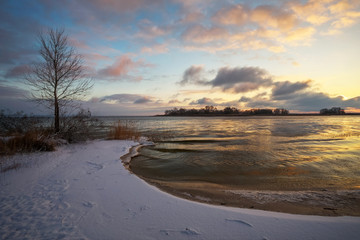Winter landscape with sunset sky and river. Daybreak