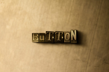 BUTTON - close-up of grungy vintage typeset word on metal backdrop. Royalty free stock - 3D rendered stock image.  Can be used for online banner ads and direct mail.