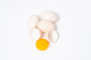 Eggs chicken bird with egg yolk and shell on a gray background