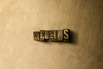 DELAYS - close-up of grungy vintage typeset word on metal backdrop. Royalty free stock - 3D rendered stock image.  Can be used for online banner ads and direct mail.