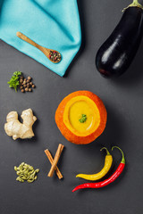 Pumpkin soup served inside of a hollowed pumpkin