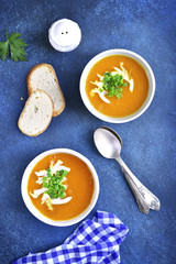 Two portions of pumpkin soup.Top view.