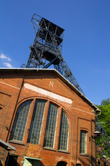 Black coal mine, Landek, Ostrava, Czech Republic / Czechia, Central Europe - tower with wheel and elevator. Detail of historical industrial architecture.Building is made of red brick masonry