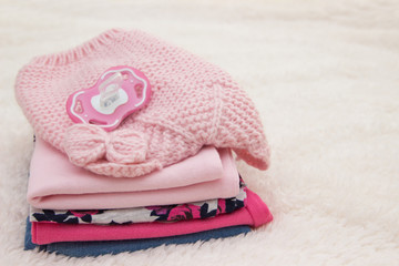 Baby clothes for newborn. In pink colors.