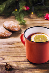 Mulled wine with lemon and a christmas lights in a background