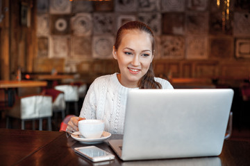 Yong woman a work at laptop in cafe