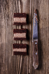 Slices of homemade chocolate cake on a wooden table