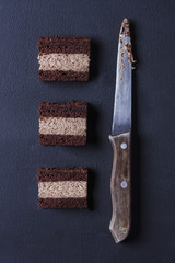 Slices of homemade chocolate cake on a dark background