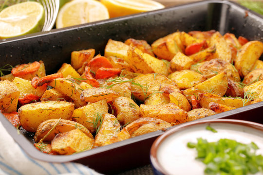 Fresh baked potatoes with herbs and lemon dip