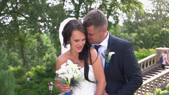 Wedding couple on nature background. Bride and groom smiling. You've scared me. Not a minute without jokes.