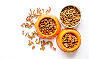 dry dog food in bowl on white background top view