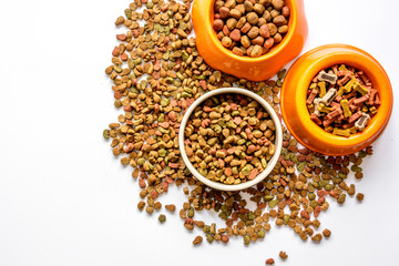 dry cat food in bowl on white background top view