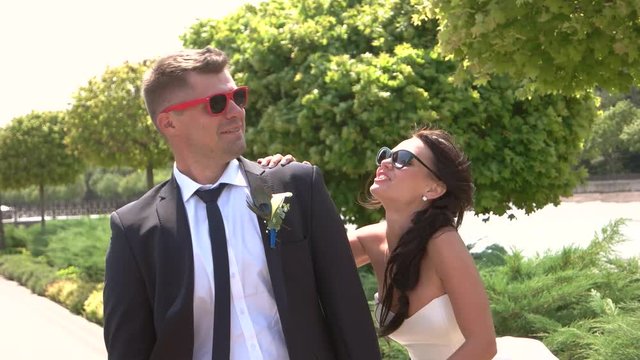 Bride and groom in sunglasses. Wedding couple kissing outdoors. Pull me closer. Magnetism of love.