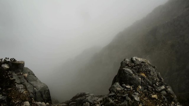 motion along the rocky terrain in autumn misty mountains