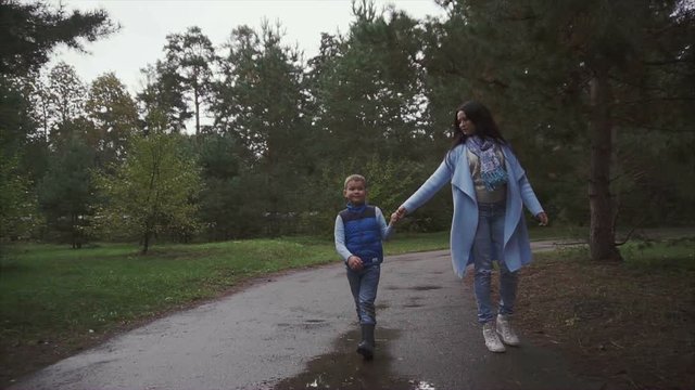 Mother and son walking in the autumn park HD