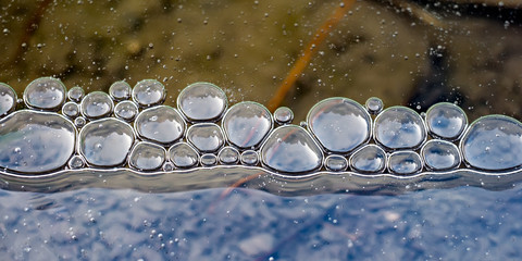 Air bubbles under the ice in winter