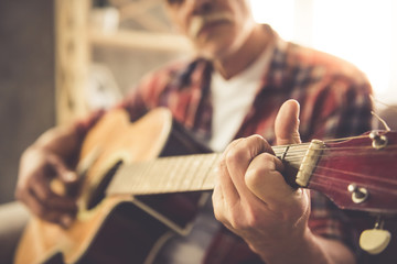 Handsome mature man with guitar - obrazy, fototapety, plakaty
