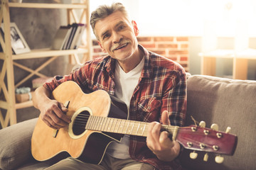 Handsome mature man with guitar
