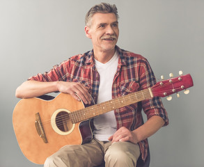 Handsome mature man with guitar