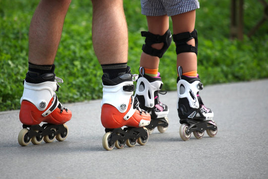 two pairs of legs on roller skates
