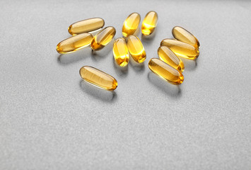 Fish oil capsules on grey background