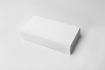 Stack of blank business cards on white background