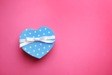 Heart shaped gift box on pink background