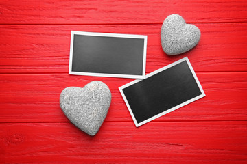 Photo cards with hearts on red table