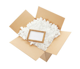 Delivery service concept. Frame in cardboard box full of polystyrene isolated on white