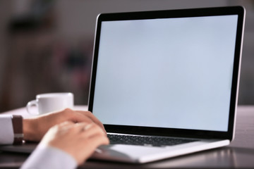Businessman using laptop, closeup