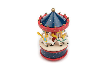 Musical carousel with horses. Blue, red, white merry go round. Toy. Vintage carousel, made from solid wood. Winter, Christmas, New Year decoration. Isolated on white background. Closeup. 