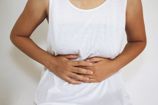 woman stomach ache because of gastritis or menstruation